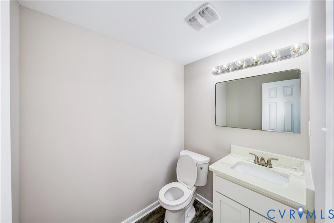 3600 Sherbrook Road Richmond, VA 23235 - Photo 21 of 26 a bathroom with a toilet sink vanity and mirror