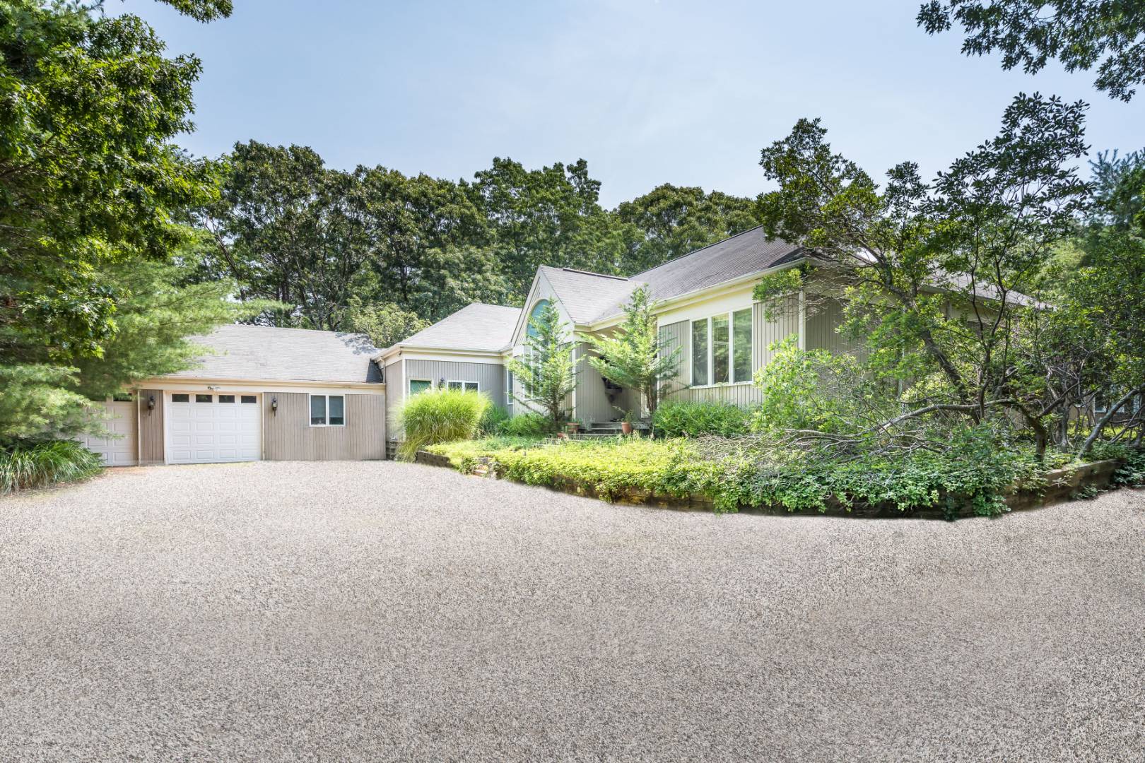 544 Wainscott NW Road East Hampton, NY 11937 - Photo 1 of 3 a front view of a house with a garden and yard