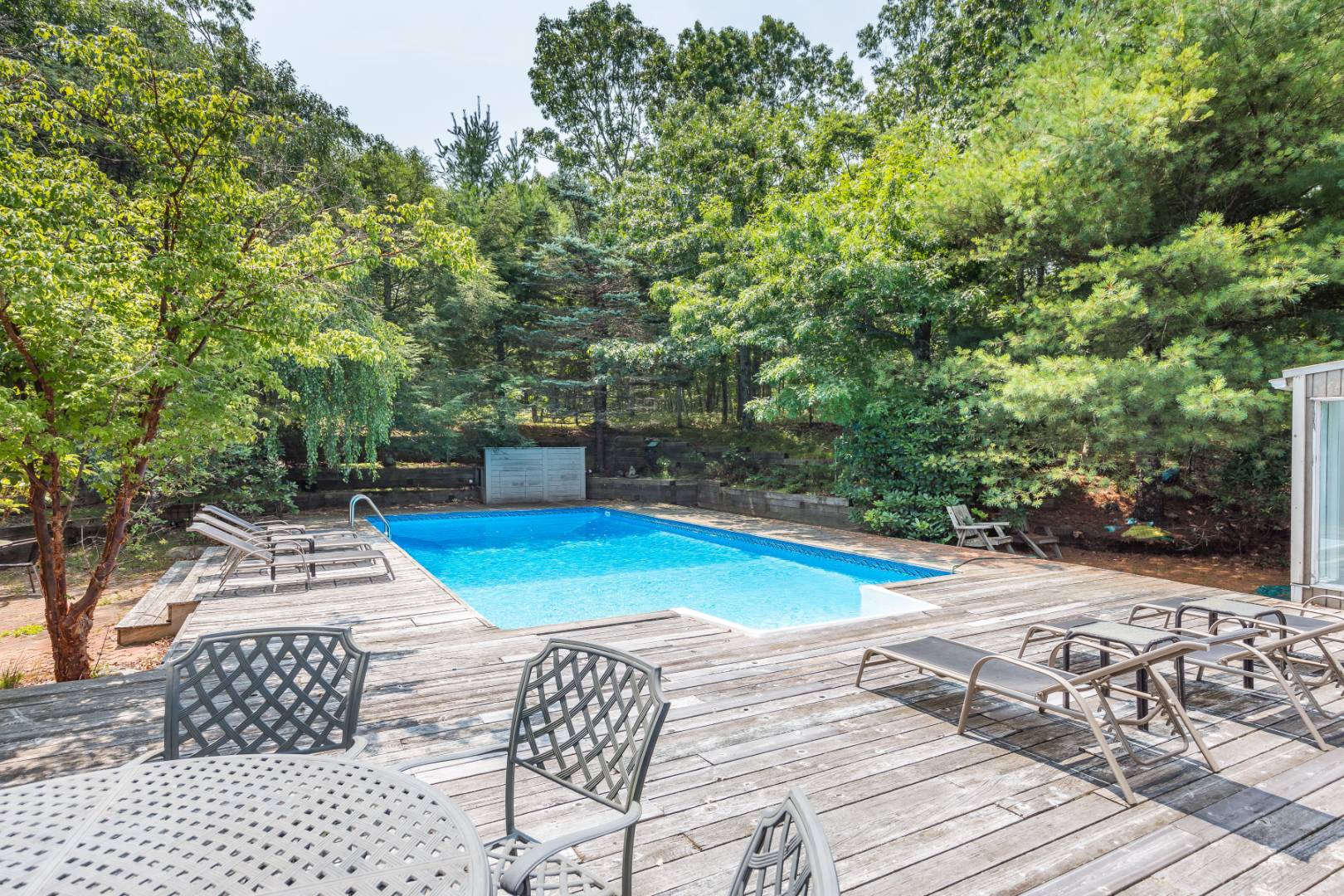 544 Wainscott NW Road East Hampton, NY 11937 - Photo 2 of 3 a view of a patio with chairs and an umbrella