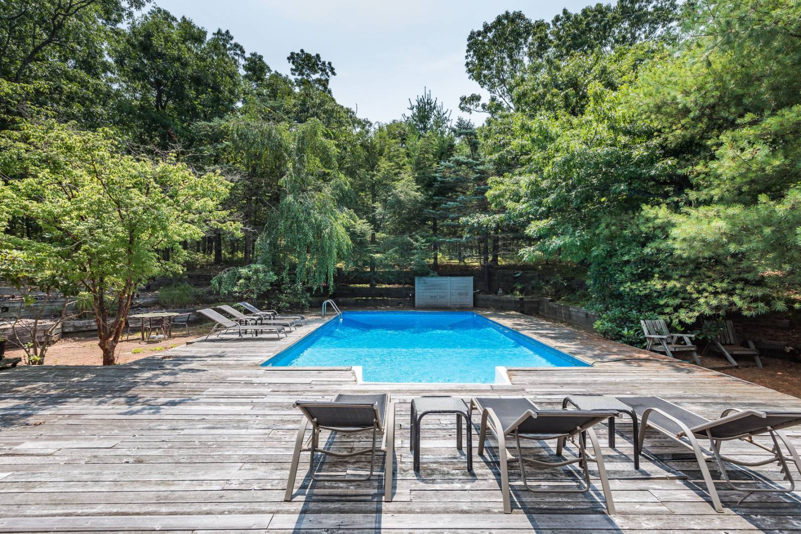 544 Wainscott NW Road East Hampton, NY 11937 - Photo 3 of 3 a view of a patio with table and chairs with wooden floor and fence