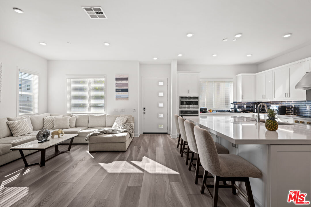 26710 Beartown Lane Stevenson Ranch, CA 91381 - Photo 1 of 21 a living room with furniture and a wooden floor