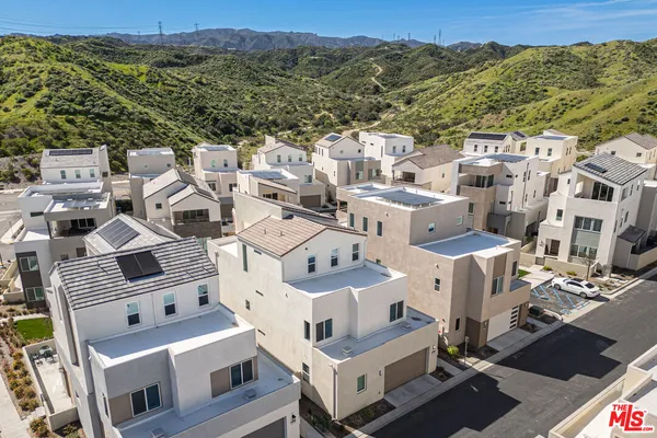 an aerial view of residential houses with outdoor space