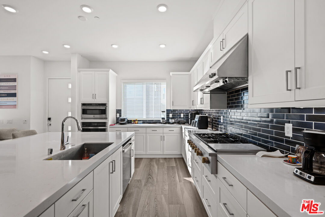 26710 Beartown Lane Stevenson Ranch, CA 91381 - Photo 2 of 21 a kitchen with a sink stainless steel appliances and cabinets