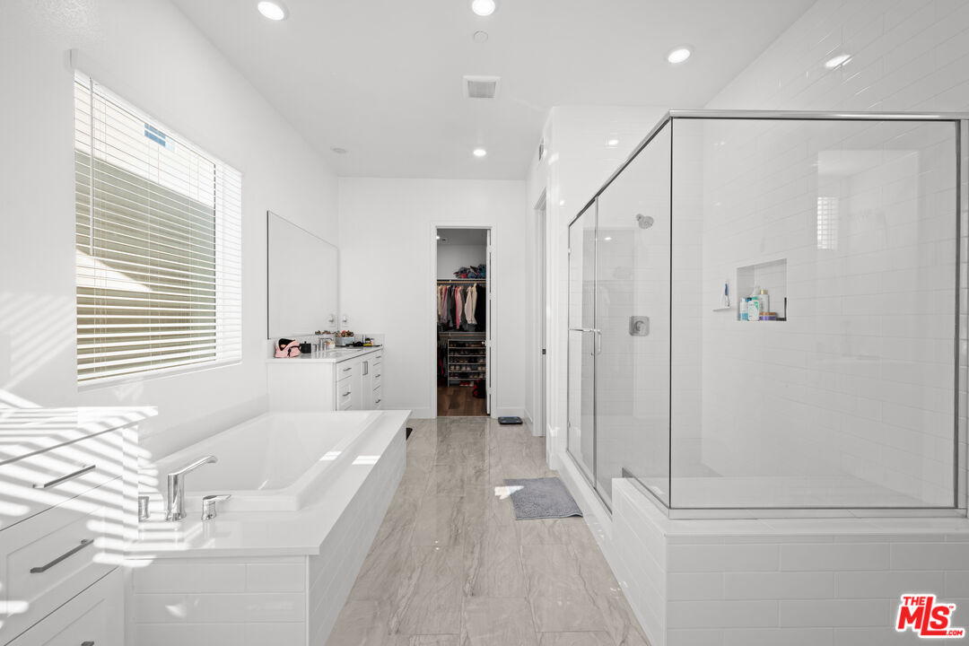 26710 Beartown Lane Stevenson Ranch, CA 91381 - Photo 8 of 21 a spacious bathroom with a tub shower and sink