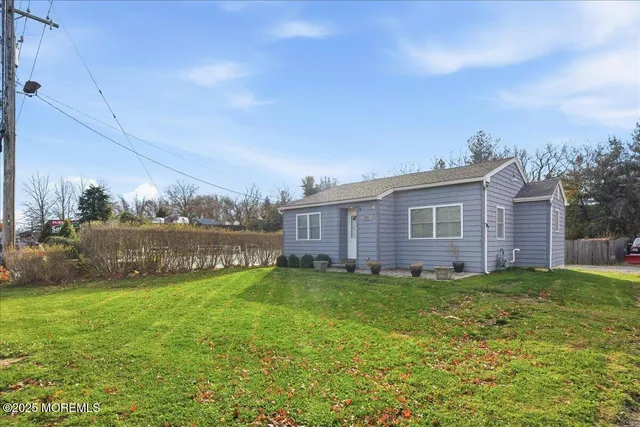a view of a house with a yard and a garden