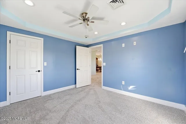 a view of an empty room with a ceiling fan