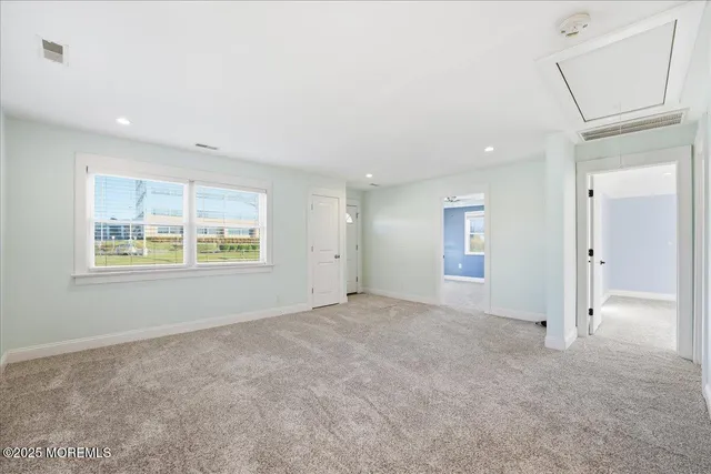 an empty room with windows and closet