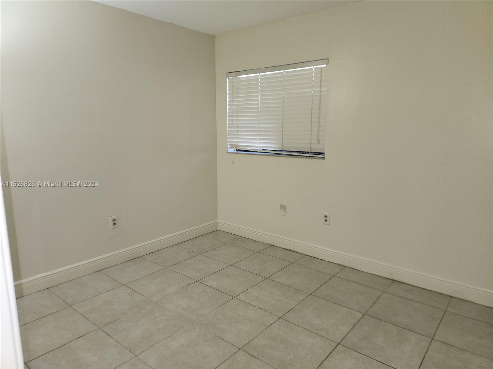 6259 West 24th Avenue, Unit 1028 Hialeah, FL 33016 - Photo 13 of 22 an empty room with a window