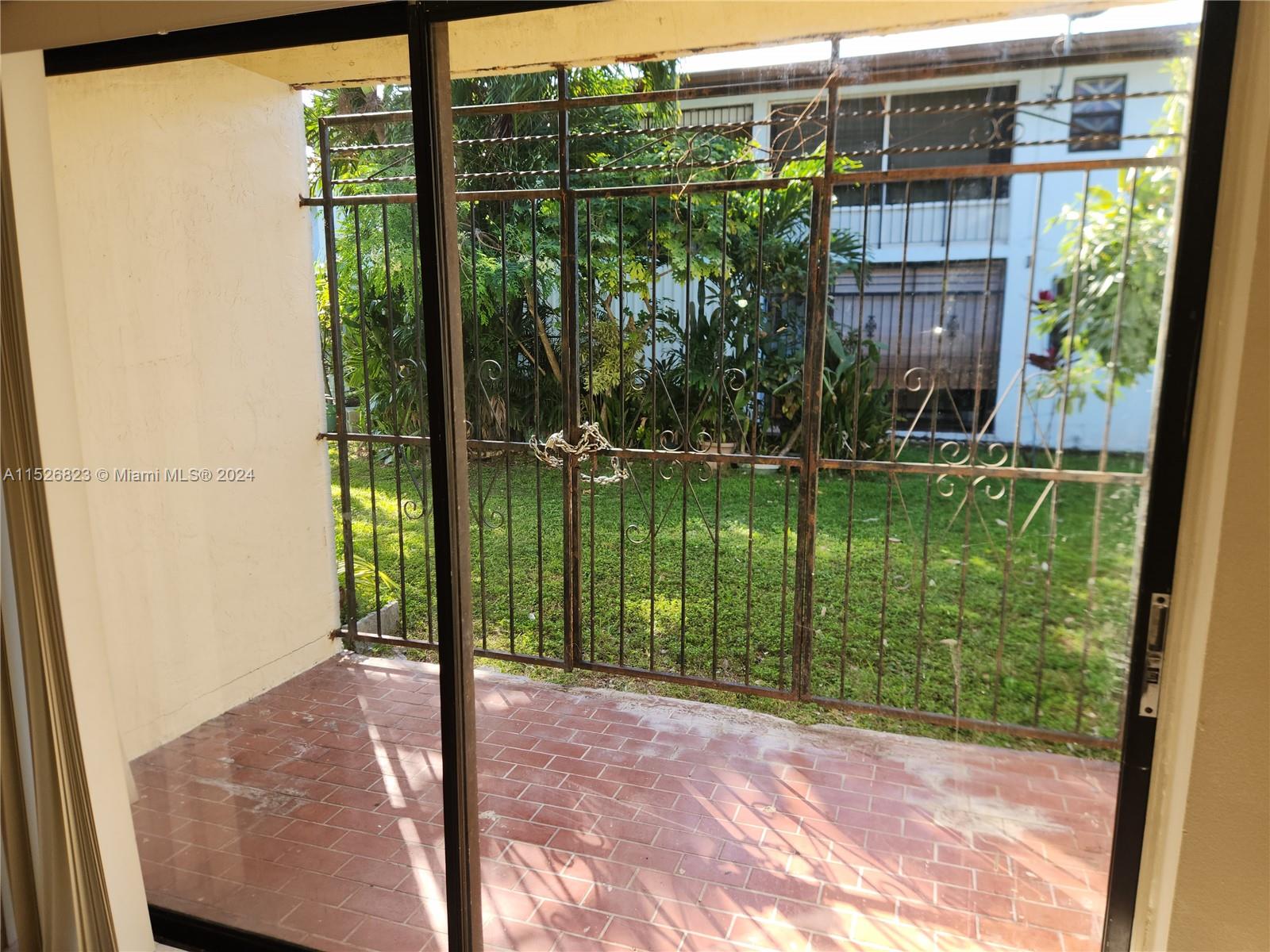 6259 West 24th Avenue, Unit 1028 Hialeah, FL 33016 - Photo 14 of 22 a view of a porch and a yard