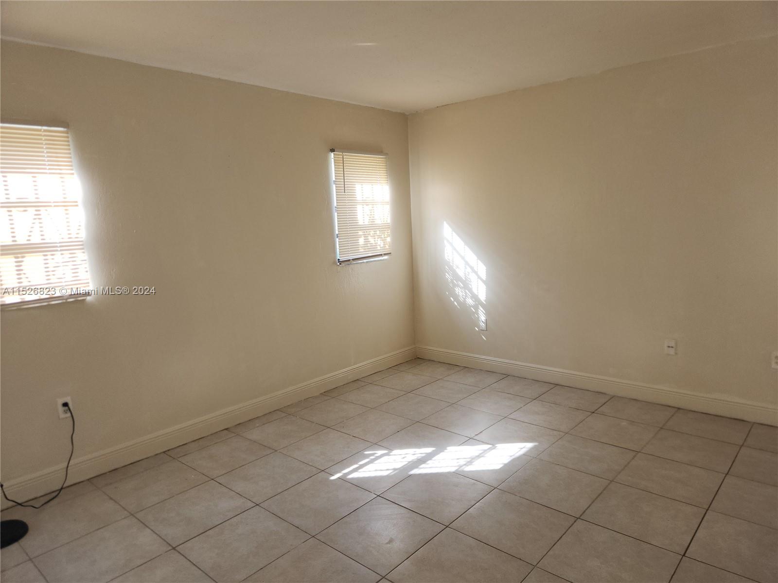 6259 West 24th Avenue, Unit 1028 Hialeah, FL 33016 - Photo 16 of 22 an empty room with windows