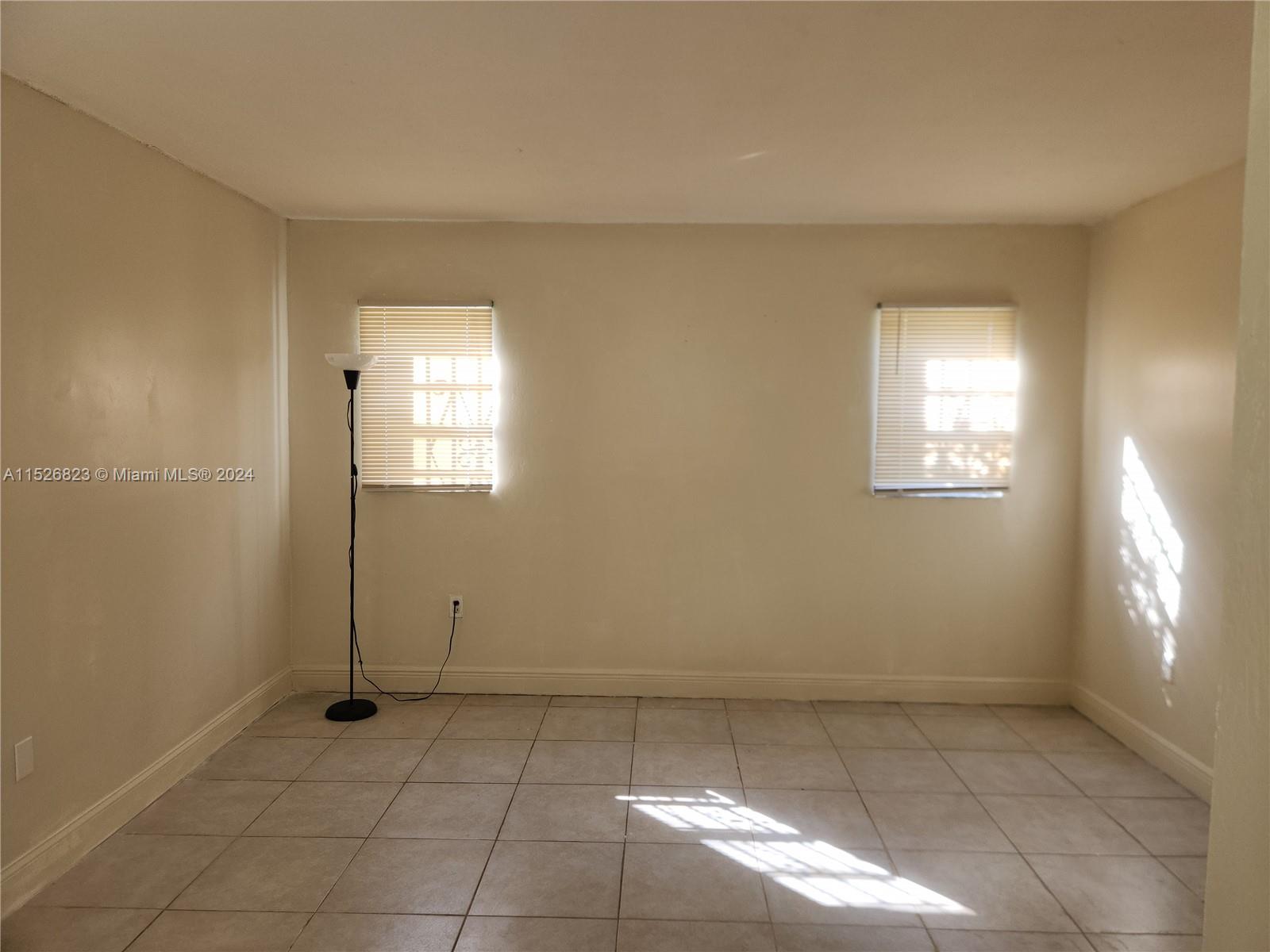 6259 West 24th Avenue, Unit 1028 Hialeah, FL 33016 - Photo 20 of 22 an empty room with windows