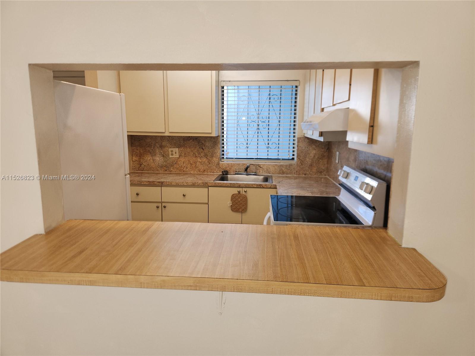 6259 West 24th Avenue, Unit 1028 Hialeah, FL 33016 - Photo 21 of 22 a large kitchen with a large window
