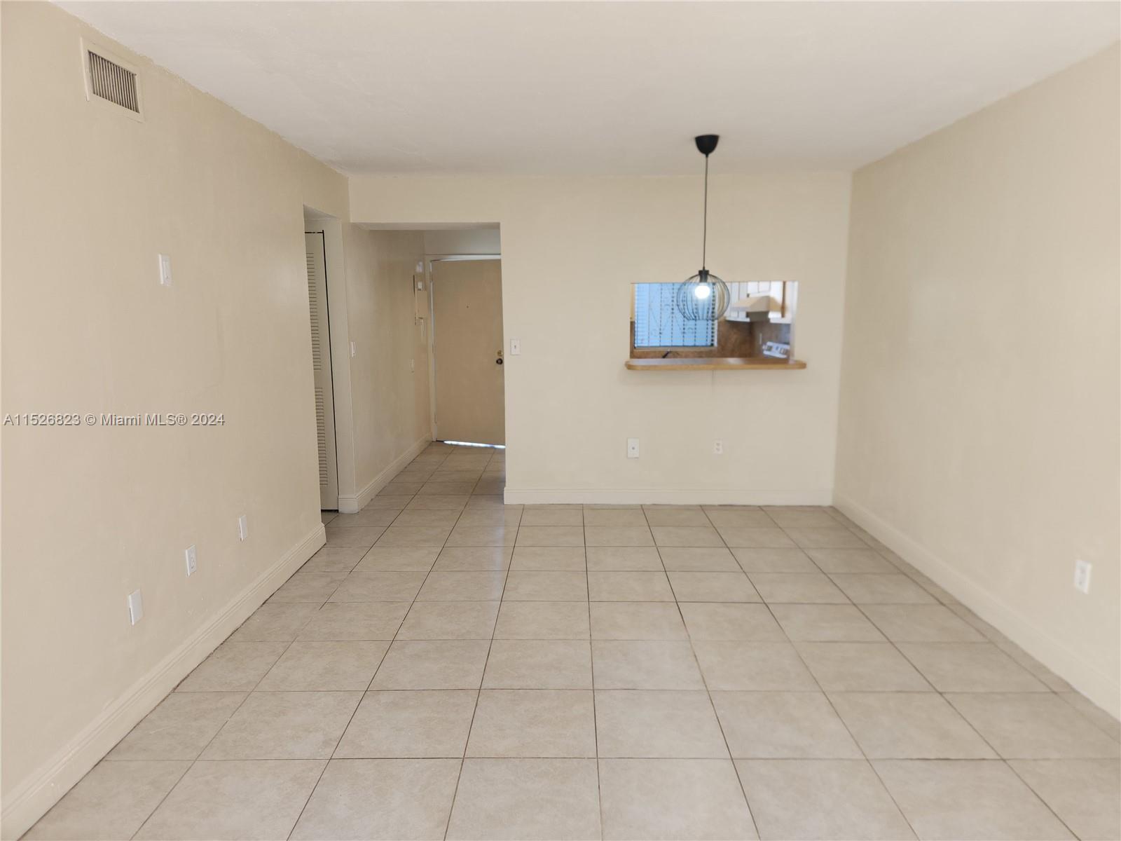 6259 West 24th Avenue, Unit 1028 Hialeah, FL 33016 - Photo 22 of 22 a view of an empty room with a window
