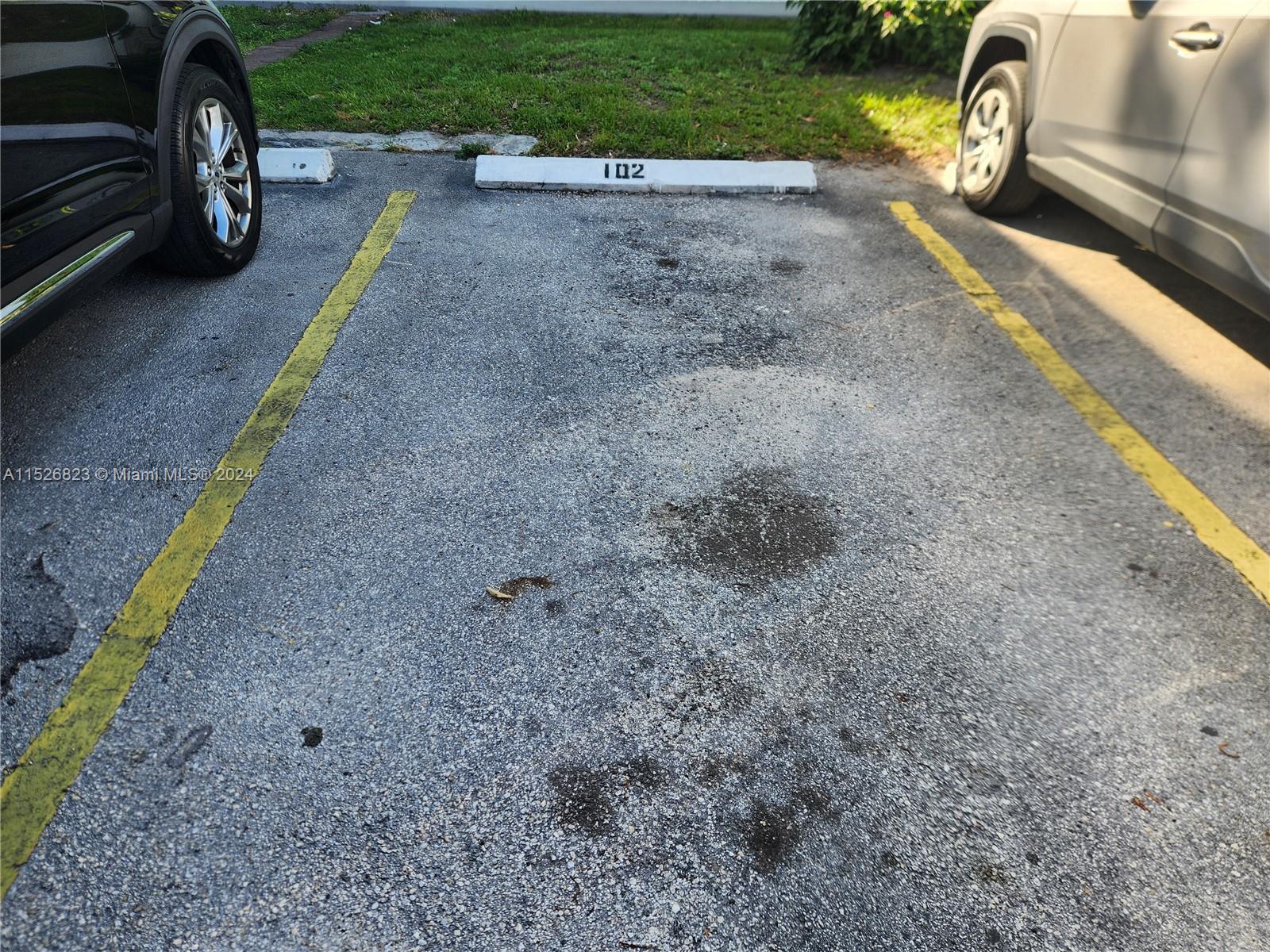 6259 West 24th Avenue, Unit 1028 Hialeah, FL 33016 - Photo 4 of 22 a view of a backyard with a car parked
