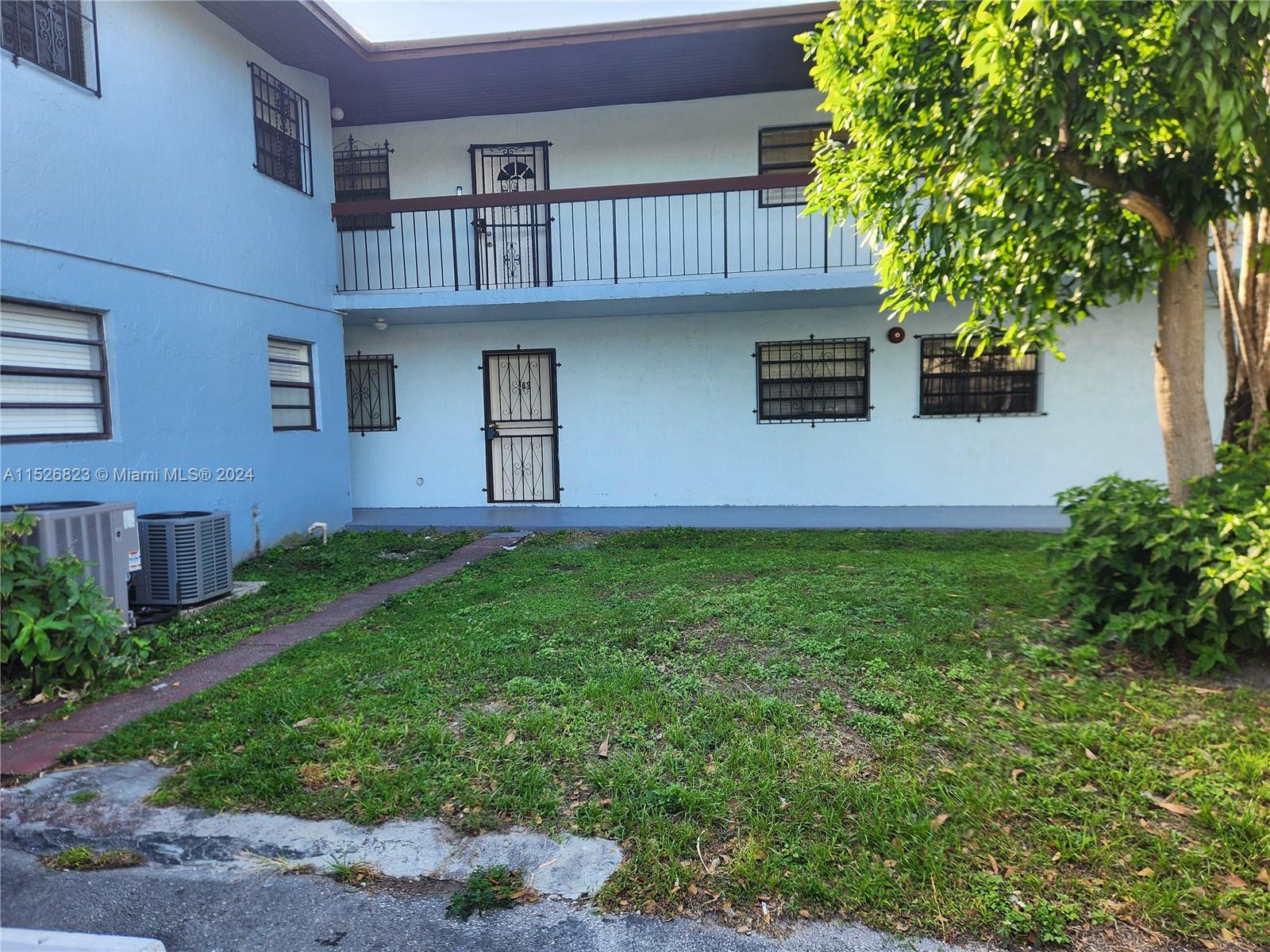 6259 West 24th Avenue, Unit 1028 Hialeah, FL 33016 - Photo 6 of 22 a front view of a house with garden