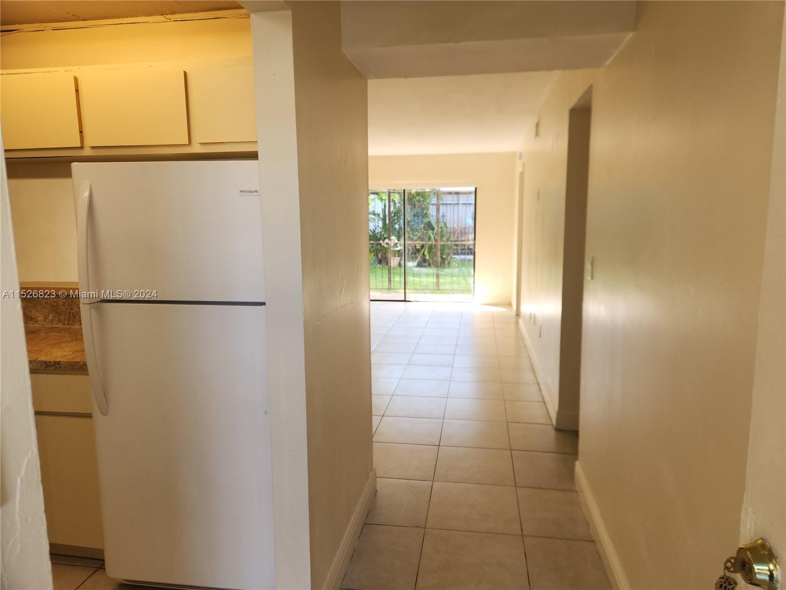 6259 West 24th Avenue, Unit 1028 Hialeah, FL 33016 - Photo 8 of 22 a view of empty room with wooden floor and cabinet