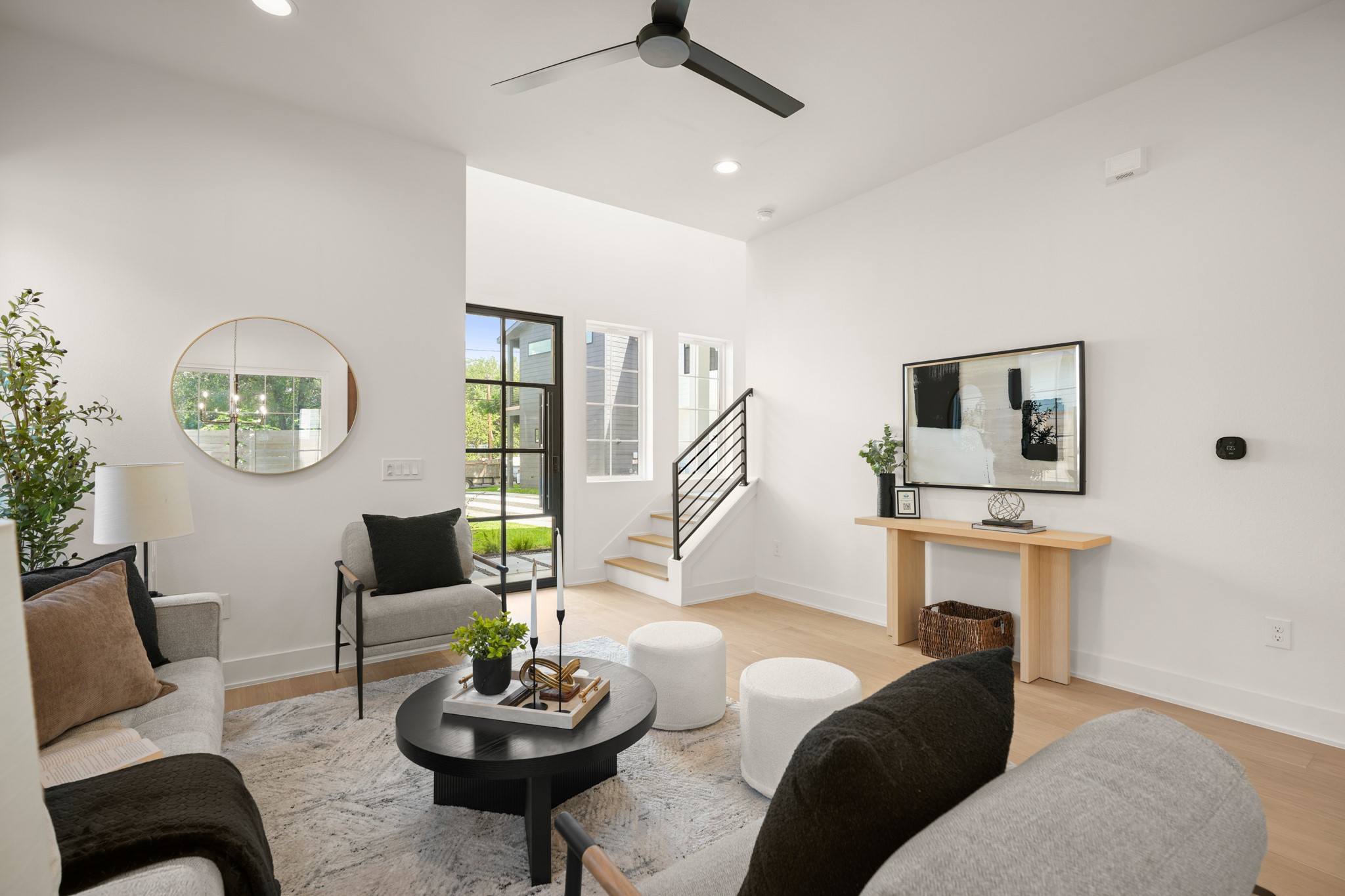 601 Vermont Road, Unit 2 Austin, TX 78702 - Photo 3 of 31 Natural light floods this living area, highlighting warm wood flooring and a clean, modern aesthetic.