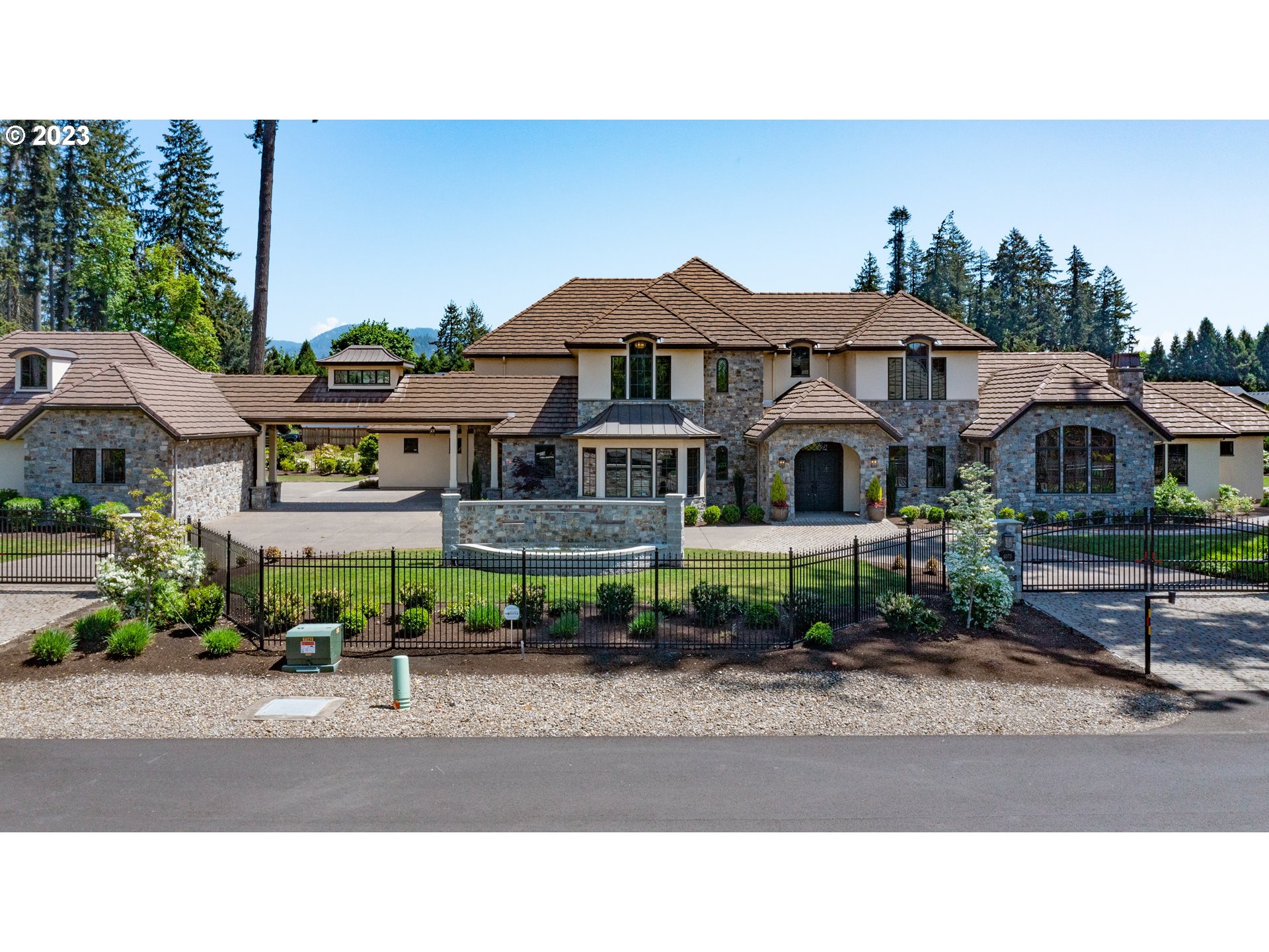 4075 Gilham Road Eugene, OR 97408 - Photo 2 of 48 a view of a white house with a big yard and potted plants