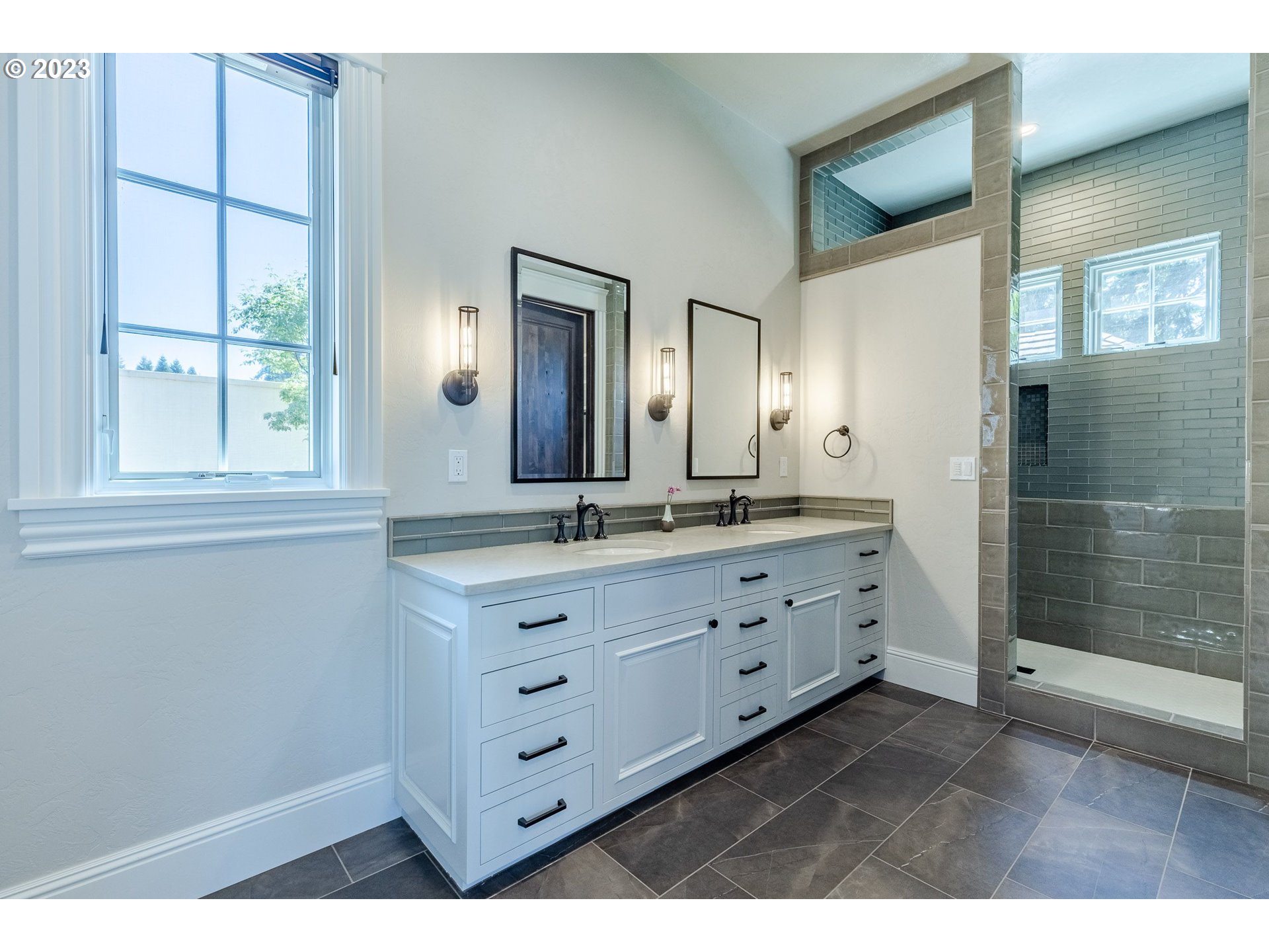 4075 Gilham Road Eugene, OR 97408 - Photo 28 of 48 a bathroom with a double vanity sink and a mirror