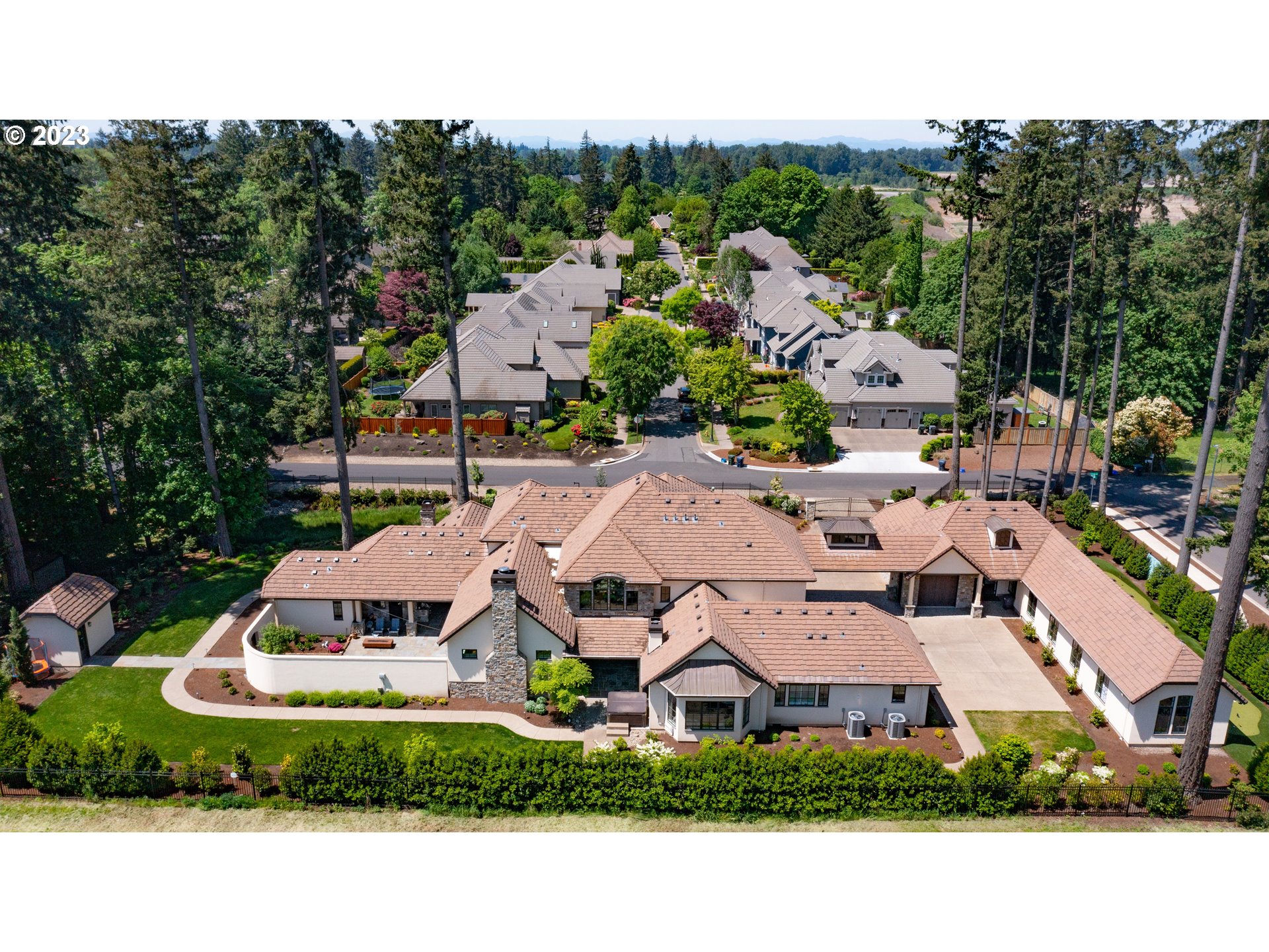 4075 Gilham Road Eugene, OR 97408 - Photo 4 of 48 a view of a white house with a big yard plants and large trees