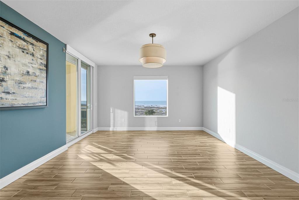 800 Collany Road, Unit 302 St. Petersburg, FL 33715 - Photo 52 of 66 a view of an empty room with wooden floor and window