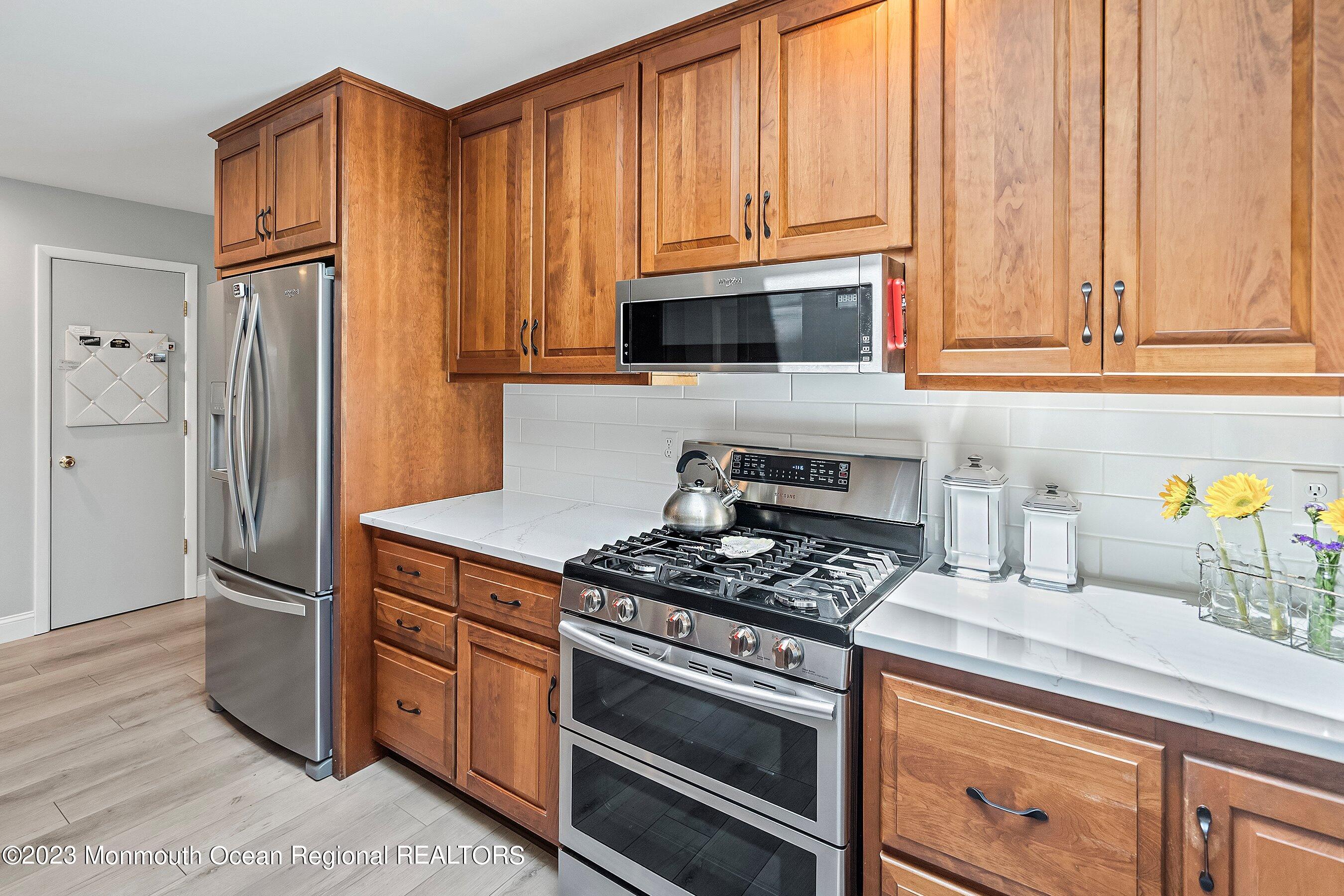 146 Peskin Road Farmingdale, NJ 07727 - Photo 13 of 31 a kitchen with stainless steel appliances granite countertop a stove a refrigerator and a microwave