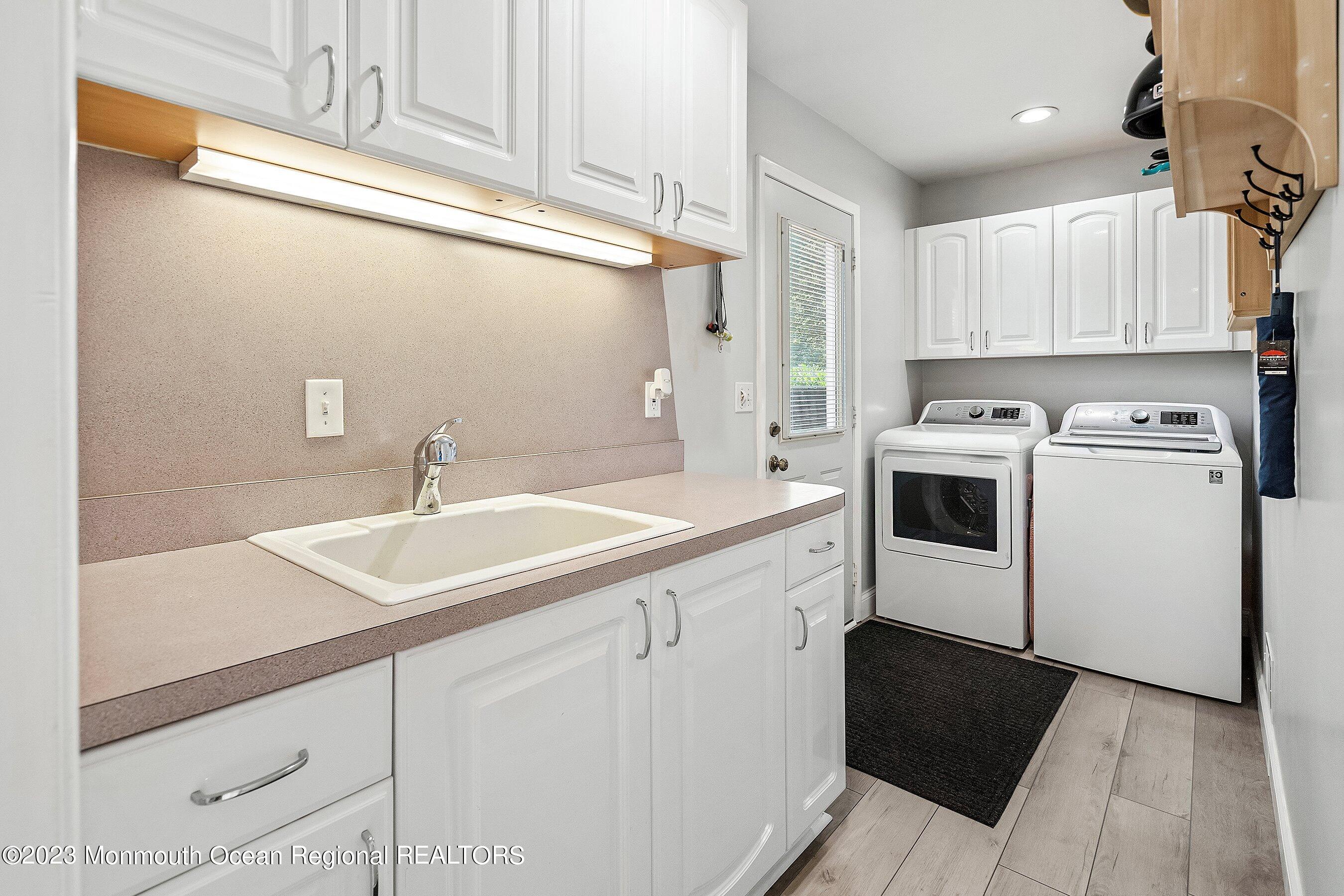 146 Peskin Road Farmingdale, NJ 07727 - Photo 14 of 31 a kitchen with a sink dishwasher and white cabinets with wooden floor