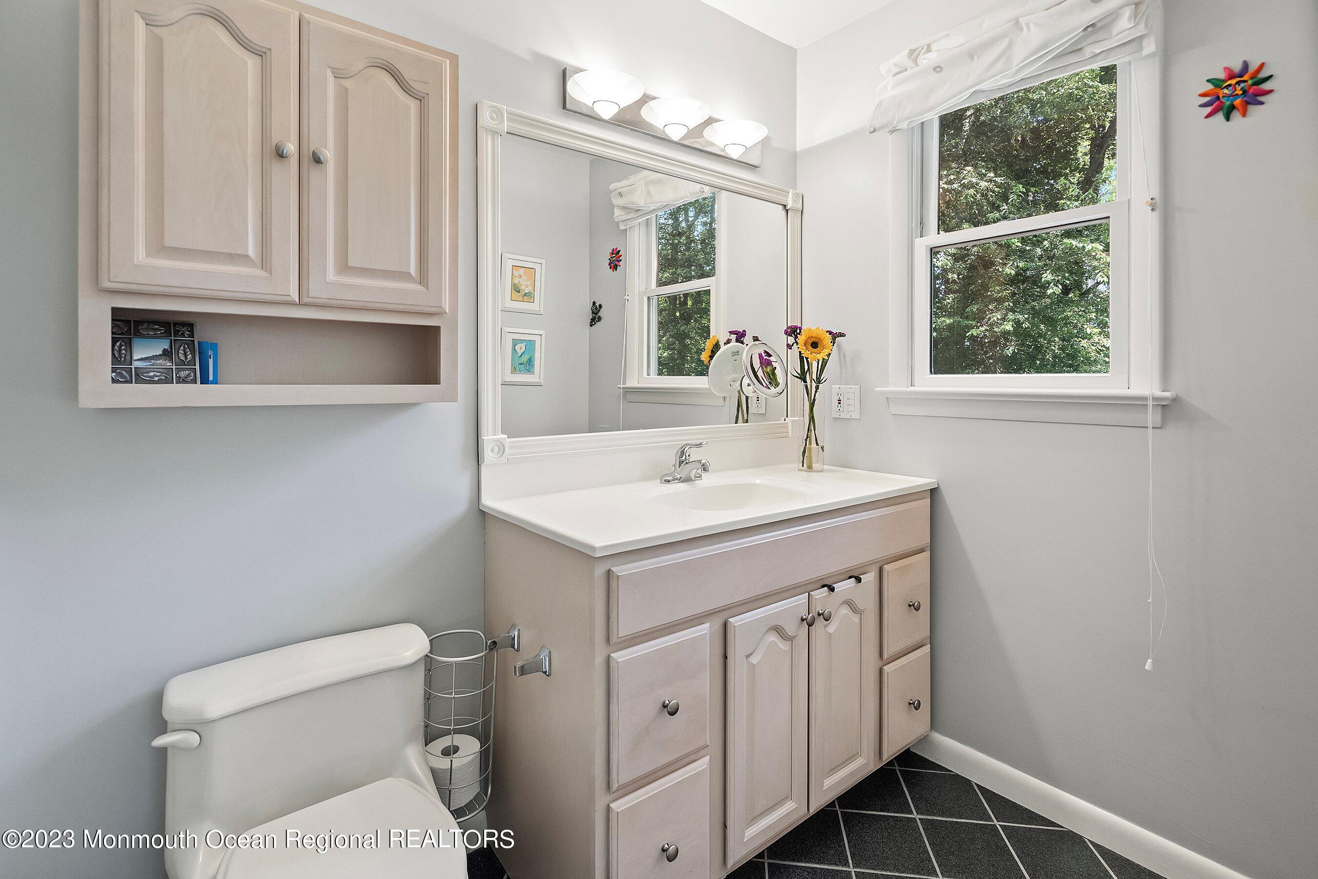 146 Peskin Road Farmingdale, NJ 07727 - Photo 22 of 31 a bathroom with a sink a toilet and a mirror