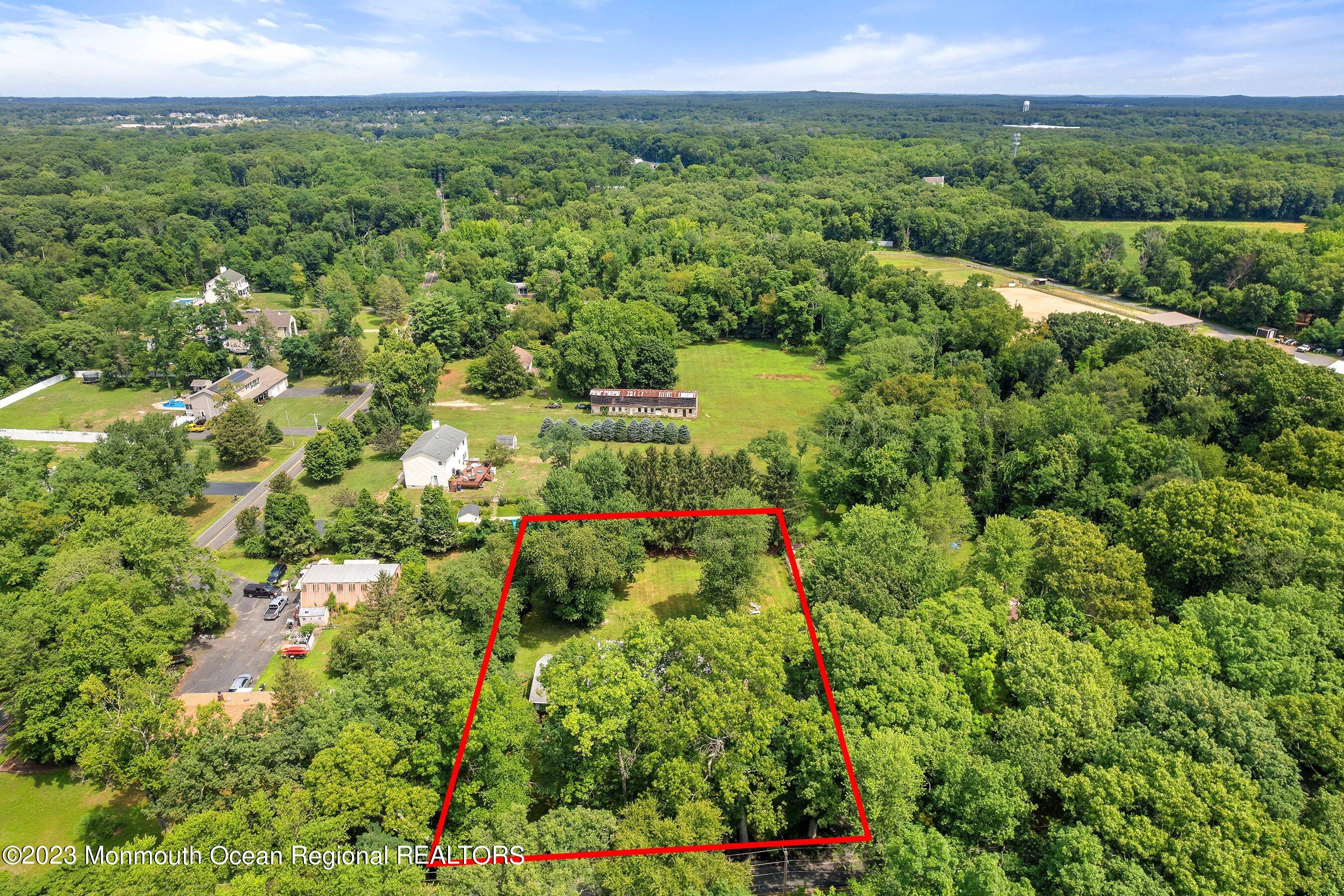 146 Peskin Road Farmingdale, NJ 07727 - Photo 3 of 31 a view of a city with lush green forest