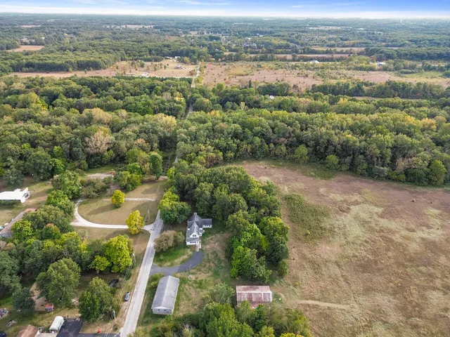 an aerial view of a houses with a yard