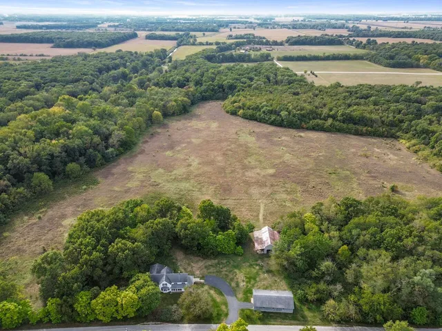 an aerial view of a houses with a lake view