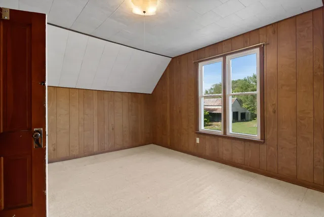 an empty room with windows and closet