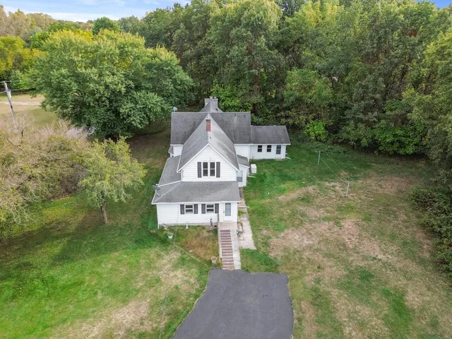 a house with green field in front of it