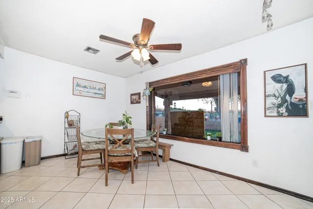 a dining room with furniture and window