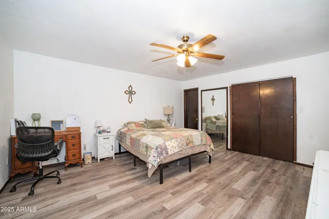 a bedroom with a bed and a chair