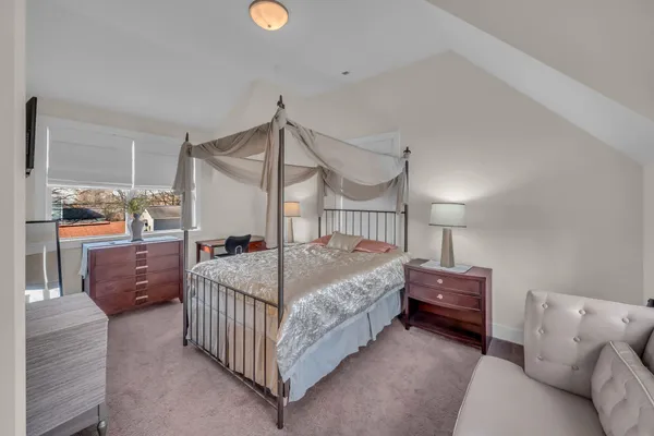 a room with a bed window and a table