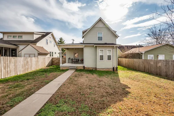 a view of a house with a yard and garage