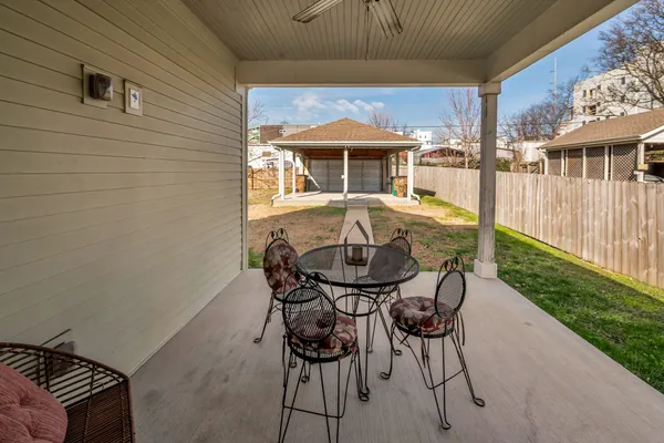 a view of a house with backyard and sitting area