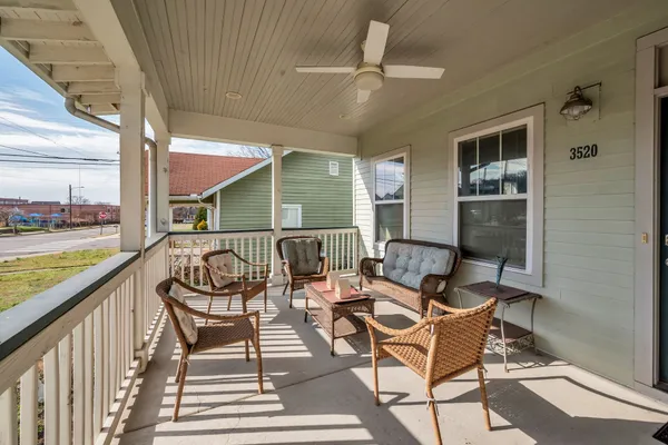 a balcony with wooden floor outdoor seating and city view