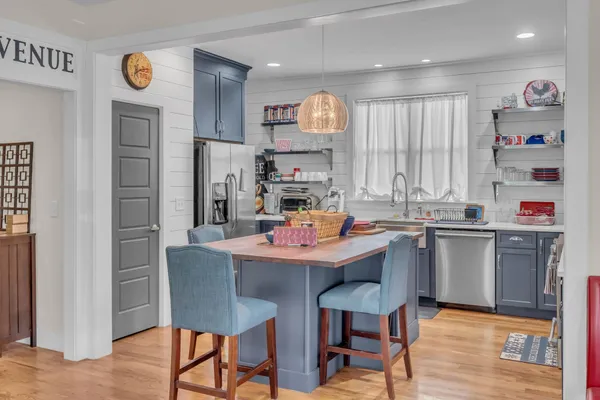 a kitchen with stainless steel appliances kitchen island granite countertop a sink and cabinets