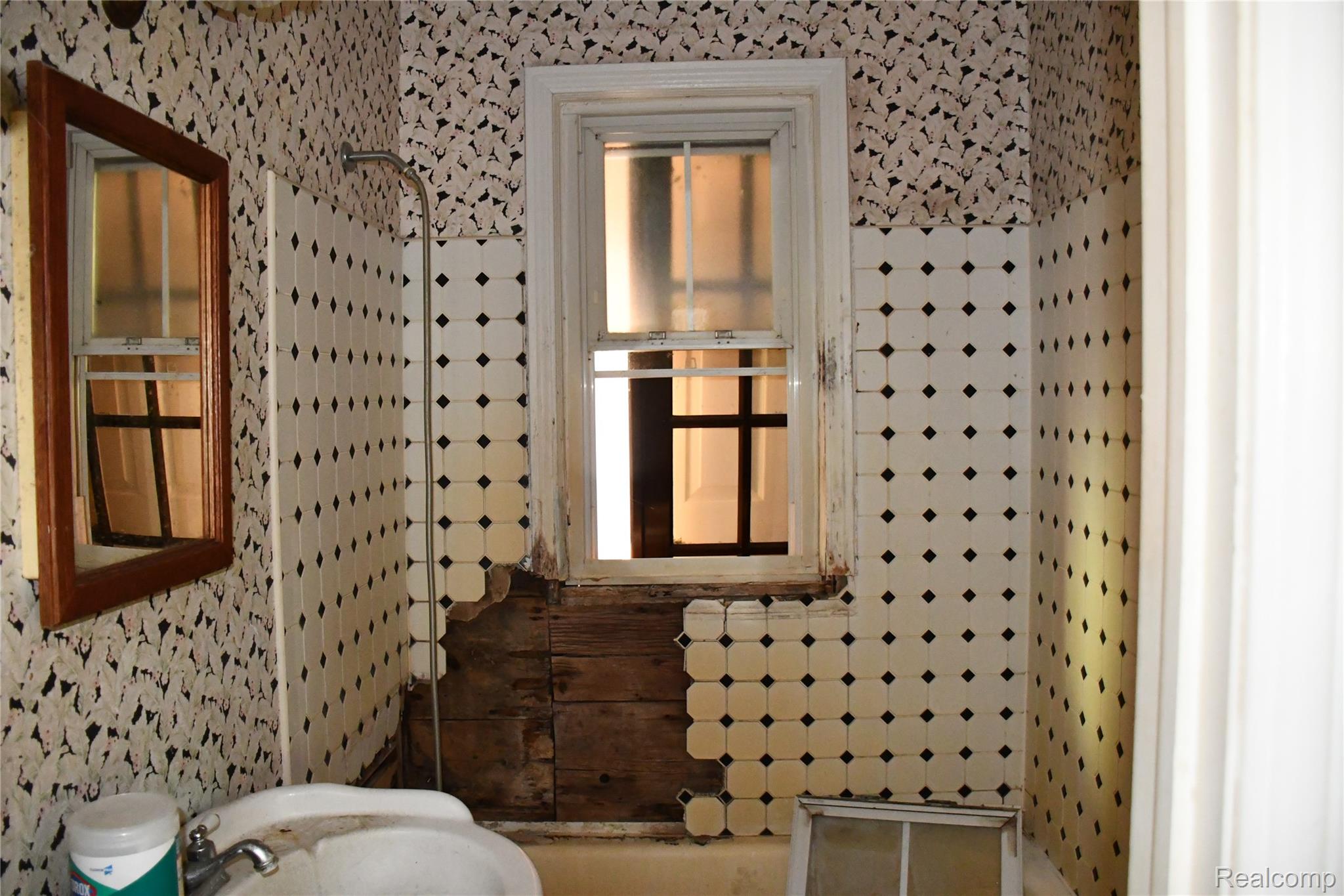 5245 East Clyde Road Howell, MI 48855 - Photo 19 of 28 Additional content
The image shows a bathroom with significant structural concerns (visible water damage and deterioration on wooden elements) that would be the unavoidable primary subject