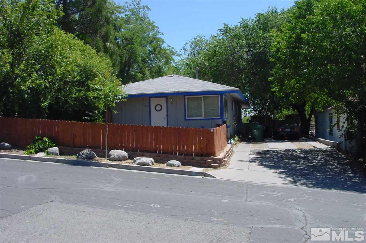 1110-1112 The Strand Reno, NV 89503 - Photo 3 of 13 a view of a small yard in front of a house with a large tree