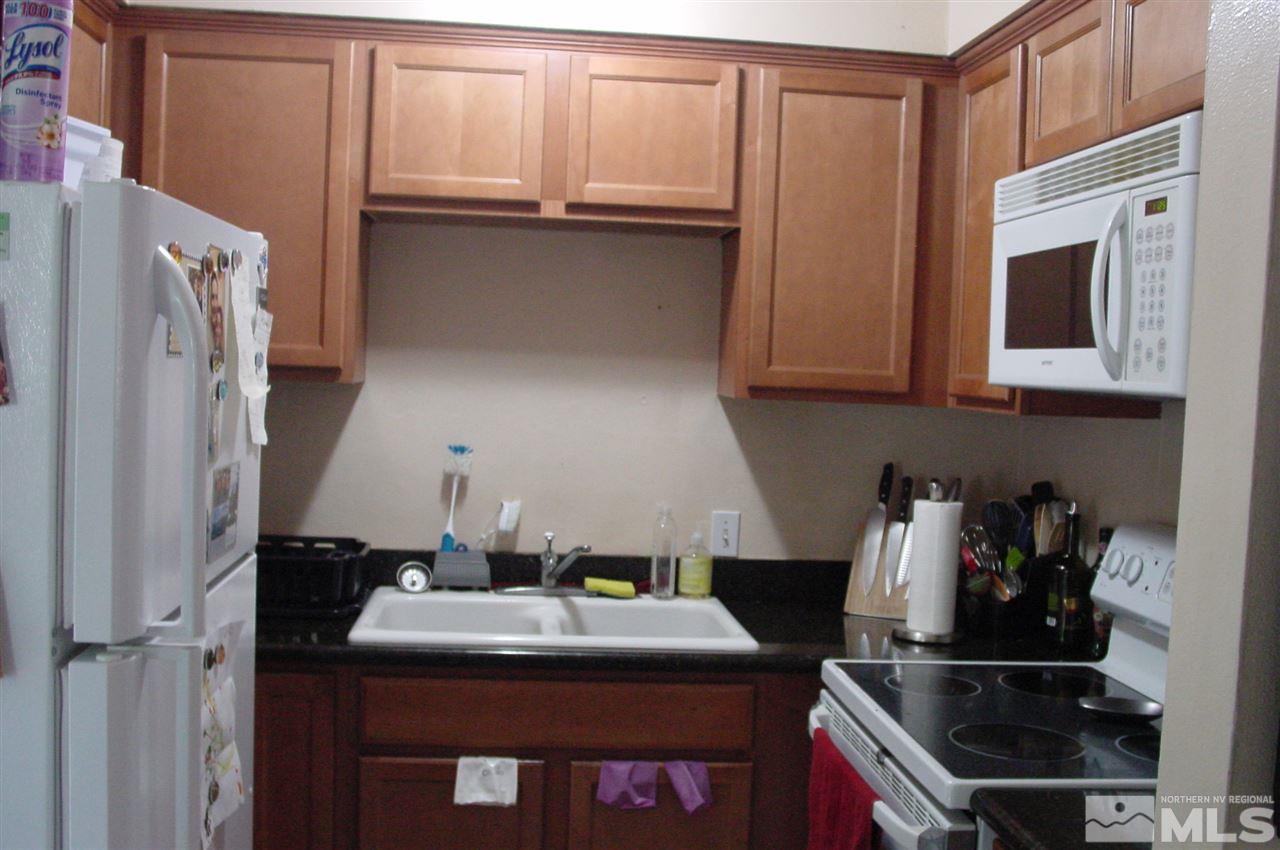1110-1112 The Strand Reno, NV 89503 - Photo 4 of 13 a kitchen with stainless steel appliances a refrigerator and a stove