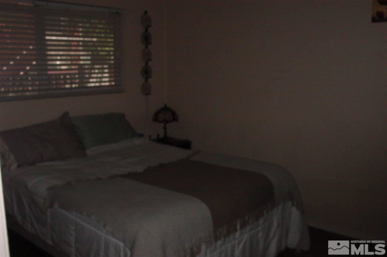 1110-1112 The Strand Reno, NV 89503 - Photo 9 of 13 a bed sitting in a bedroom next to a window