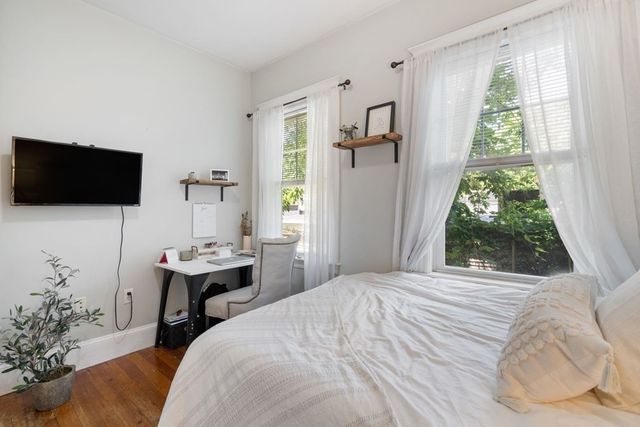 a bedroom with a bed and a flat screen tv