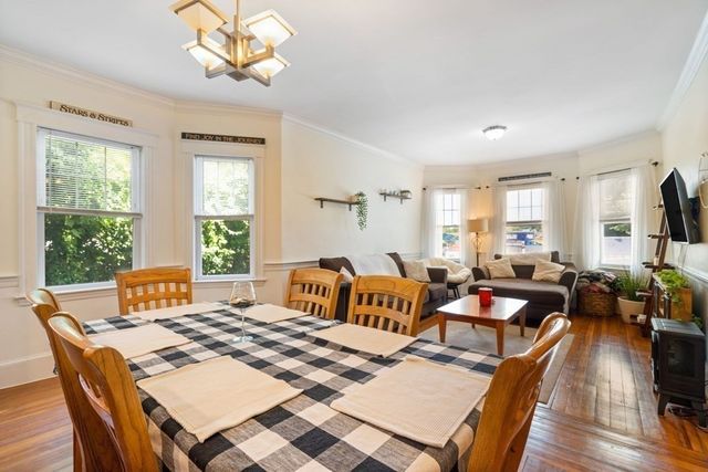 a bedroom with furniture a chandelier and a window