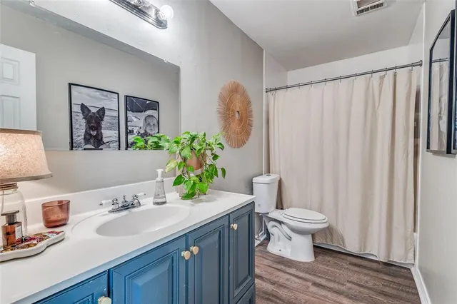 a living room with furniture a ceiling fan and a window