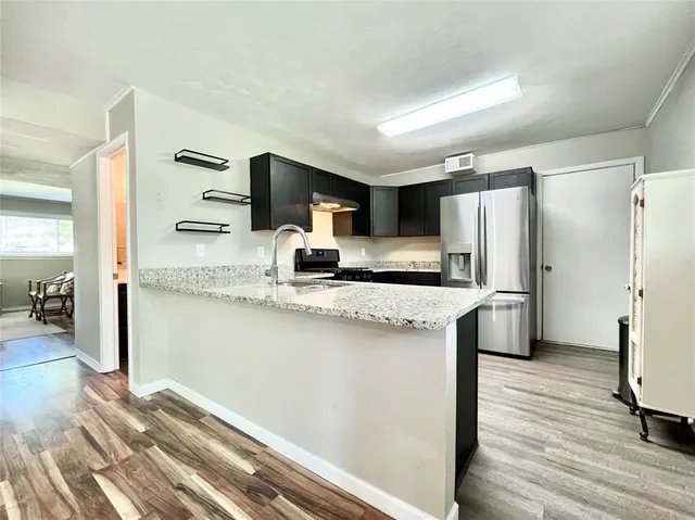 a bathroom with a granite countertop sink and a toilet