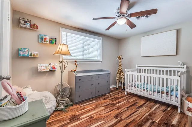 a bedroom with furniture and a wooden floor