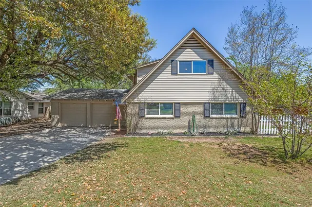 a front view of house with yard and trees